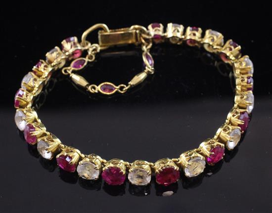 A Middle Eastern high carat gold, ruby and white topaz bracelet, gross weight 17 grams.